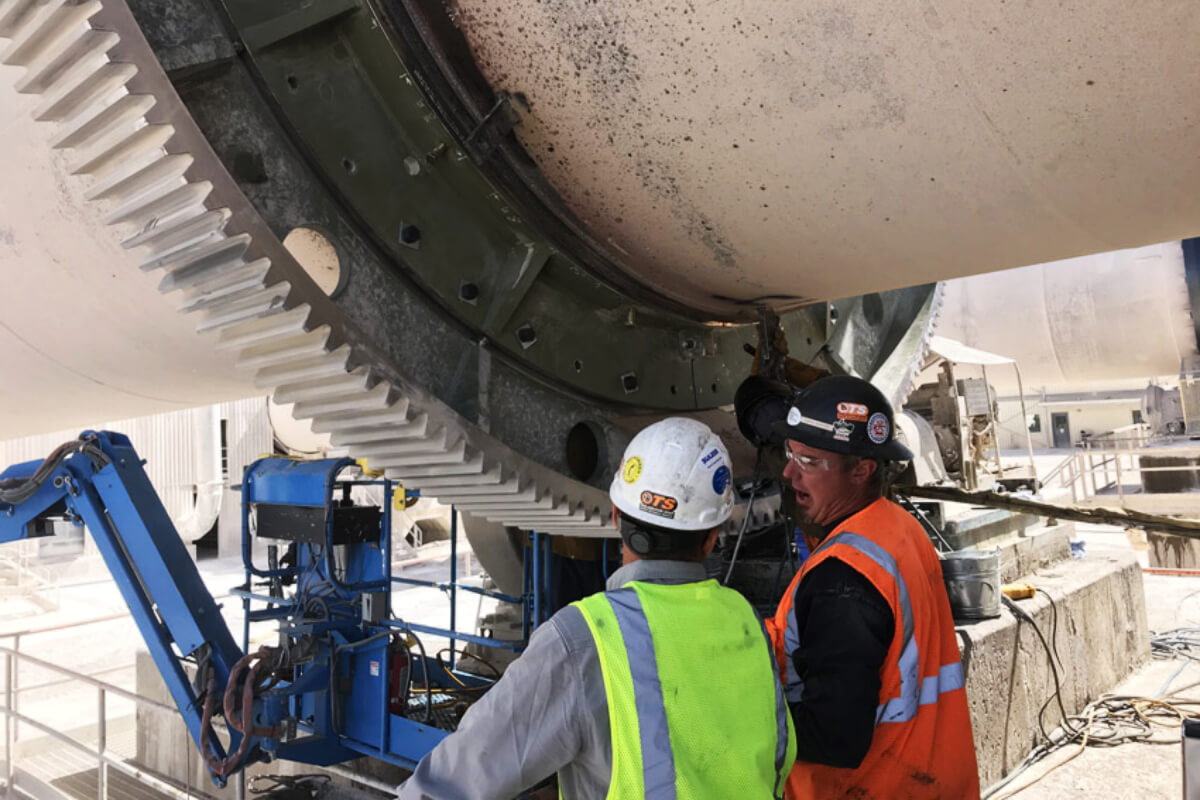 Workers inspecting kiln drive 